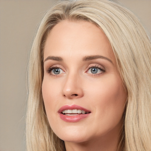 Joyful white young-adult female with long  brown hair and blue eyes