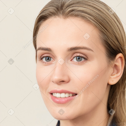 Joyful white young-adult female with long  brown hair and blue eyes