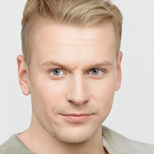 Joyful white young-adult male with short  brown hair and blue eyes