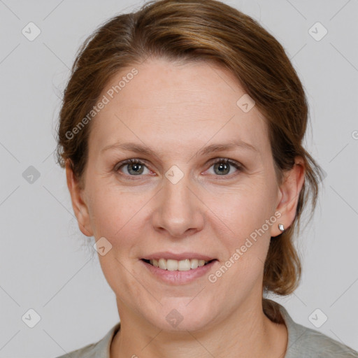 Joyful white adult female with medium  brown hair and grey eyes