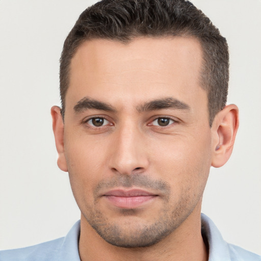 Joyful white young-adult male with short  brown hair and brown eyes