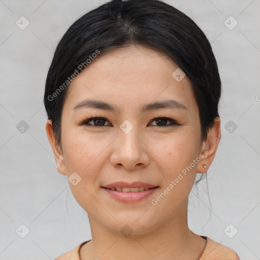 Joyful asian young-adult female with short  brown hair and brown eyes