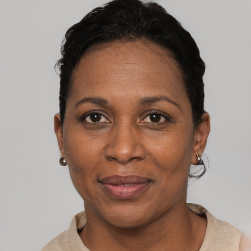 Joyful black adult female with short  black hair and brown eyes