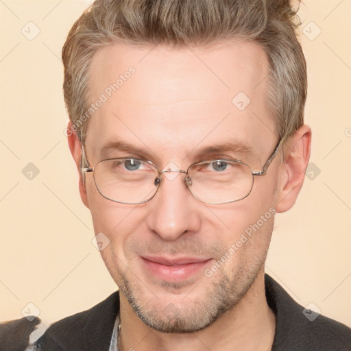 Joyful white adult male with short  brown hair and brown eyes