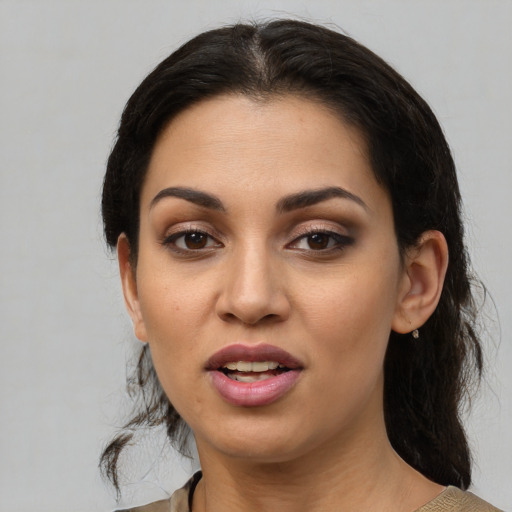 Joyful latino young-adult female with medium  black hair and brown eyes