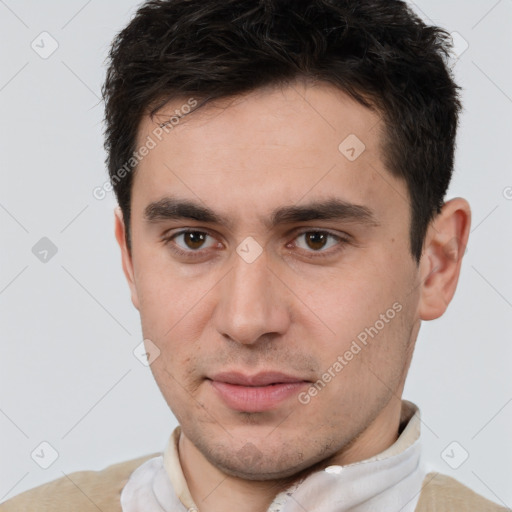 Joyful white young-adult male with short  brown hair and brown eyes