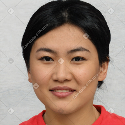 Joyful asian young-adult female with medium  black hair and brown eyes