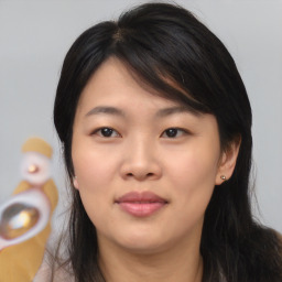 Joyful asian young-adult female with medium  brown hair and brown eyes