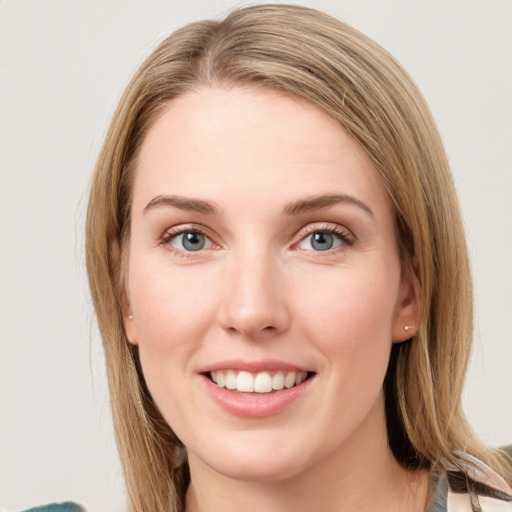 Joyful white young-adult female with long  brown hair and blue eyes