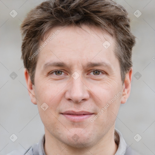 Joyful white adult male with short  brown hair and grey eyes