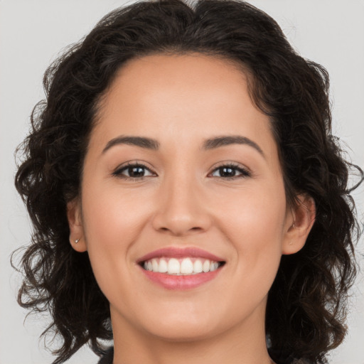 Joyful white young-adult female with long  brown hair and brown eyes