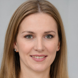 Joyful white young-adult female with long  brown hair and grey eyes