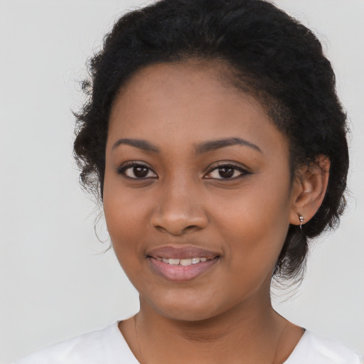 Joyful latino young-adult female with long  black hair and brown eyes