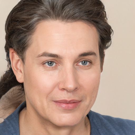 Joyful white adult male with medium  brown hair and brown eyes