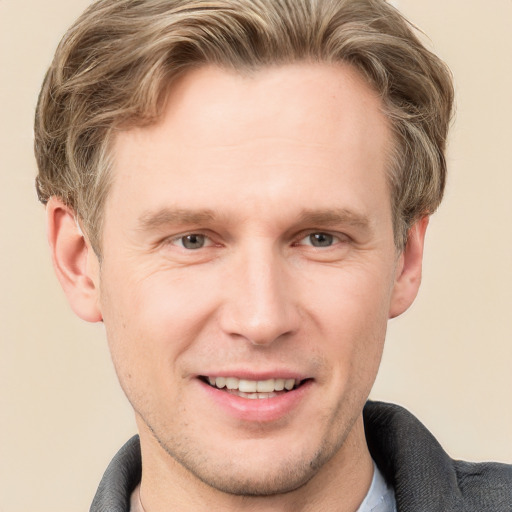 Joyful white adult male with short  brown hair and grey eyes