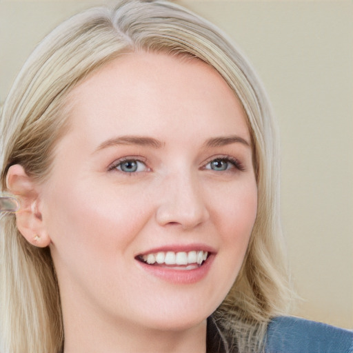 Joyful white young-adult female with long  brown hair and blue eyes