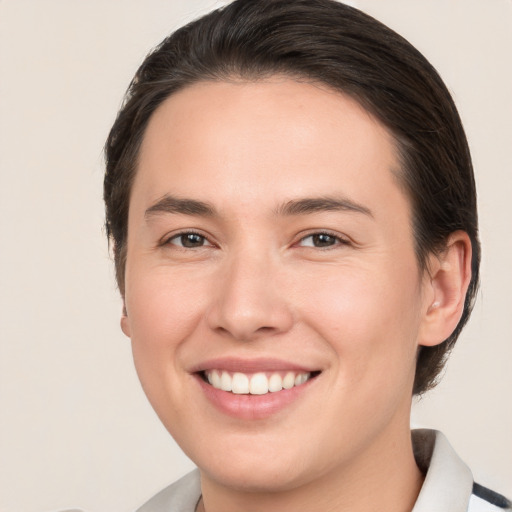 Joyful white young-adult female with short  brown hair and brown eyes