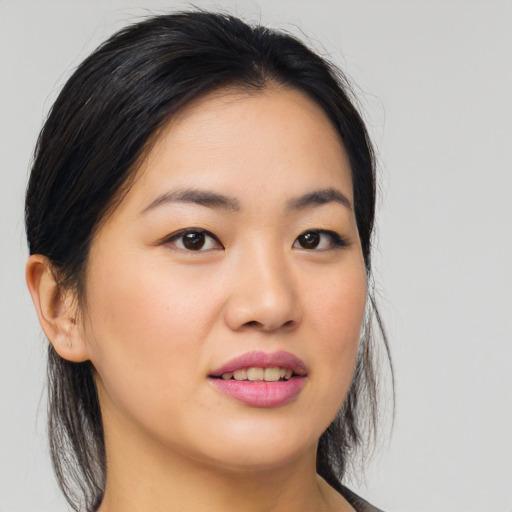 Joyful asian young-adult female with medium  brown hair and brown eyes