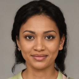 Joyful black young-adult female with medium  brown hair and brown eyes