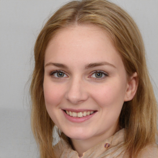 Joyful white young-adult female with long  brown hair and blue eyes