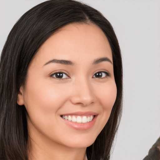 Joyful white young-adult female with long  brown hair and brown eyes