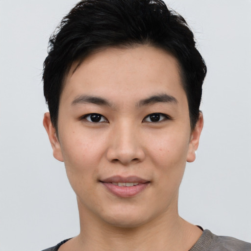 Joyful asian young-adult female with short  black hair and brown eyes