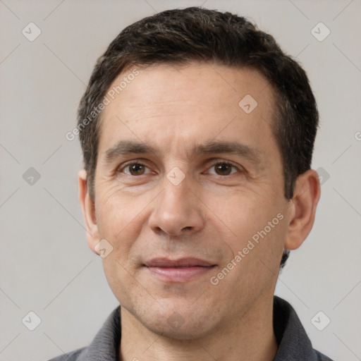 Joyful white adult male with short  brown hair and brown eyes