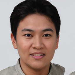 Joyful asian young-adult male with short  black hair and brown eyes