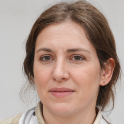 Joyful white adult female with medium  brown hair and brown eyes