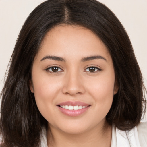 Joyful white young-adult female with long  brown hair and brown eyes