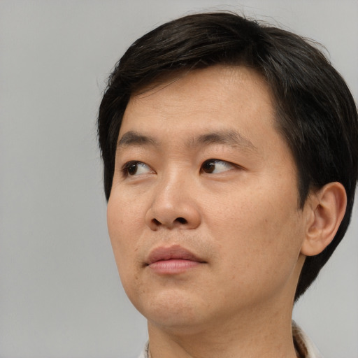 Neutral asian young-adult male with short  brown hair and brown eyes