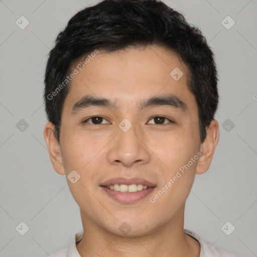 Joyful asian young-adult male with short  black hair and brown eyes