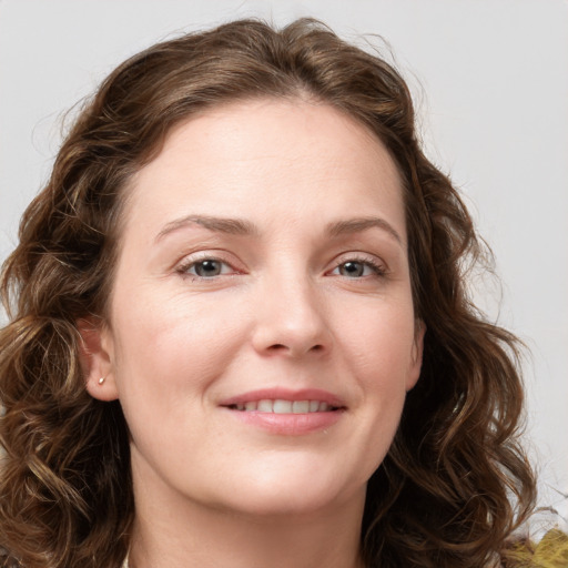 Joyful white young-adult female with long  brown hair and green eyes