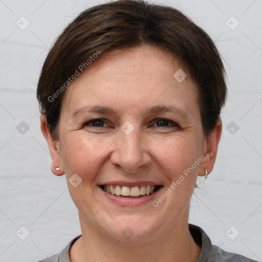 Joyful white adult female with short  brown hair and grey eyes