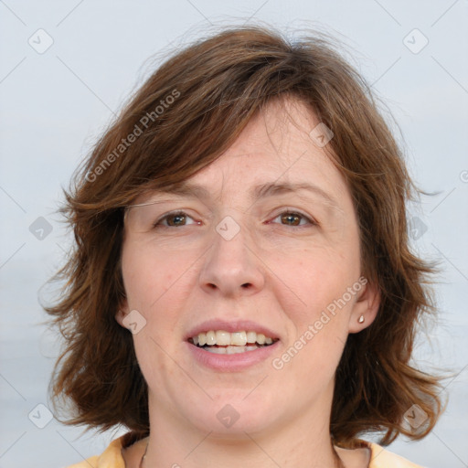 Joyful white adult female with medium  brown hair and blue eyes