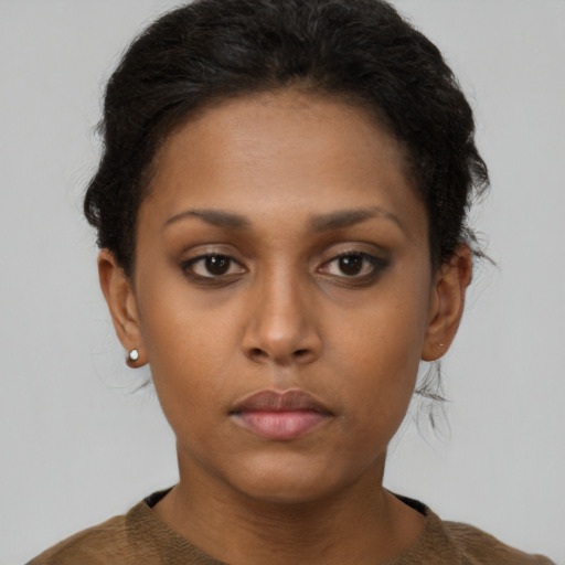 Neutral black young-adult female with short  brown hair and brown eyes