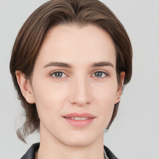 Joyful white young-adult female with medium  brown hair and grey eyes