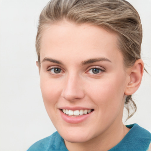 Joyful white young-adult female with medium  brown hair and blue eyes