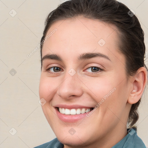 Joyful white young-adult female with medium  brown hair and grey eyes