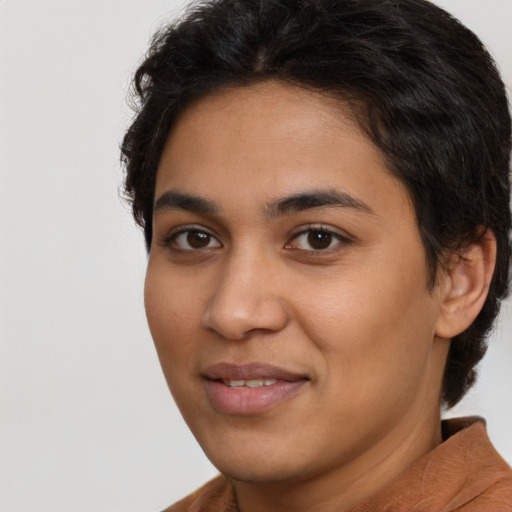 Joyful latino young-adult female with short  brown hair and brown eyes