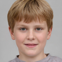 Joyful white child male with short  brown hair and grey eyes