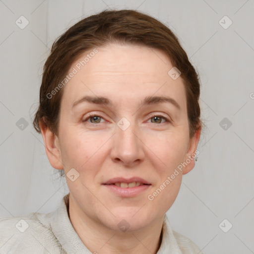 Joyful white adult female with short  brown hair and grey eyes