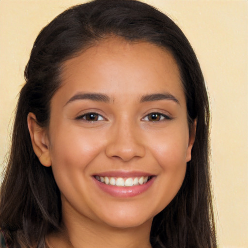 Joyful latino young-adult female with long  brown hair and brown eyes