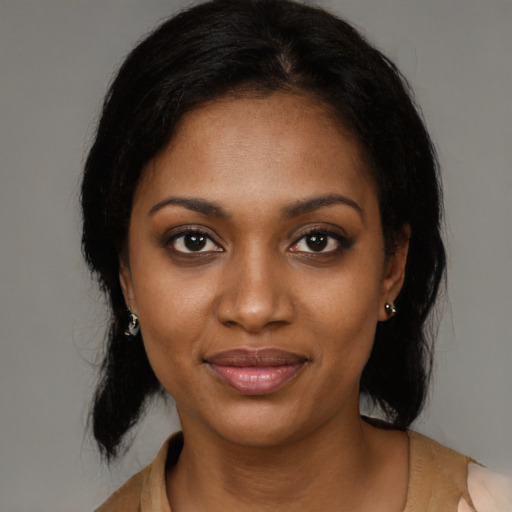 Joyful black young-adult female with medium  black hair and brown eyes