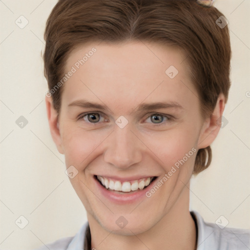 Joyful white young-adult female with short  brown hair and grey eyes