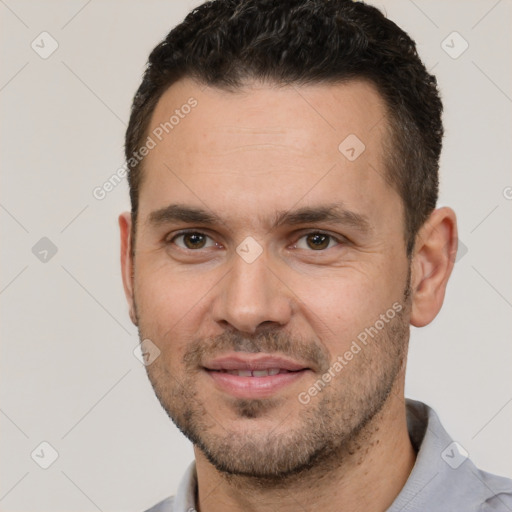 Joyful white adult male with short  brown hair and brown eyes