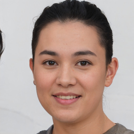 Joyful white young-adult female with short  black hair and brown eyes