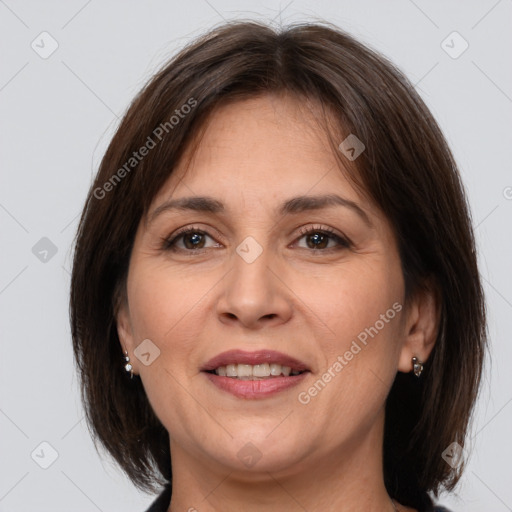 Joyful white adult female with medium  brown hair and brown eyes