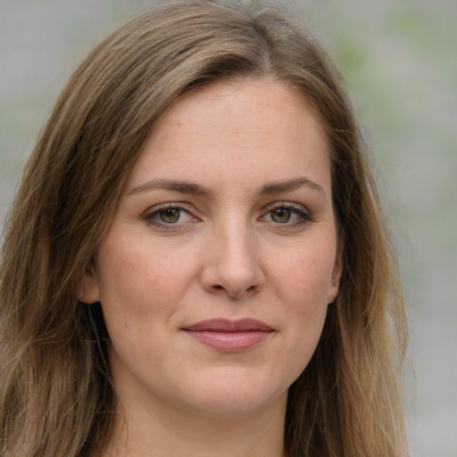 Joyful white young-adult female with long  brown hair and green eyes