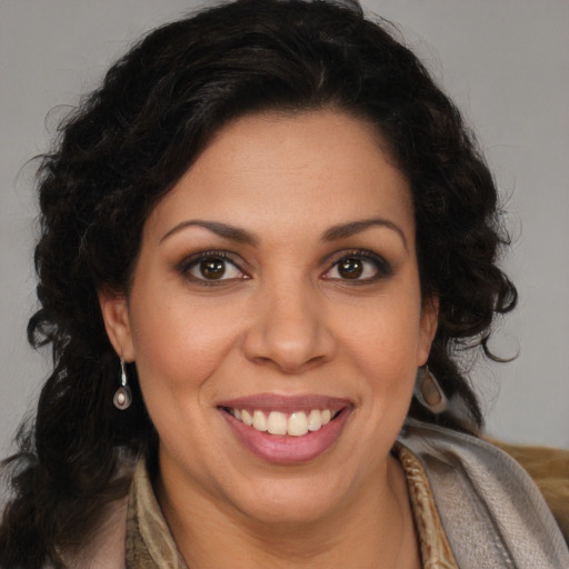 Joyful latino young-adult female with long  brown hair and brown eyes